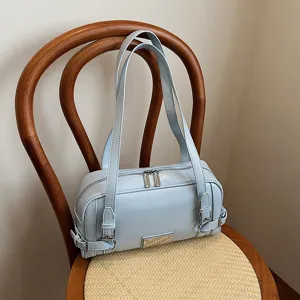 Light blue stylish women shoulder bag bowling purse with dual straps and chic buckle details.
