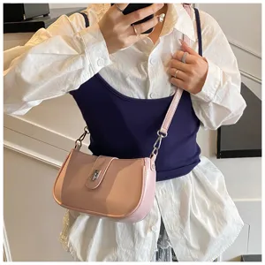 Pink PU leather underarm shoulder bag detail, showcasing the metallic twist-lock closure.