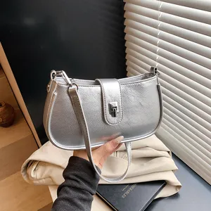 Stylish silver metallic shoulder bag for women, trendy underarm bag with secure lock.