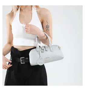 Detailed close-up of silver leather Boston handbag featuring metallic zippers and handle.