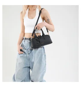 Stylish black leather Boston shoulder bag with top handles and adjustable strap for women.