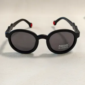Kids black round polarized sunglasses detail view, UV400 protection summer outdoor eyewear.