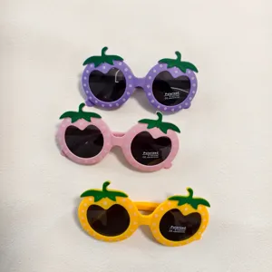 Close-up details of cute strawberry-shaped children sunglasses featuring fun polka dot frames.