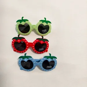 Kids strawberry sunglasses detail, cute polarized eyewear, UV400 protection, stylish shades.