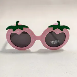 Cute strawberry shaped children sunglasses detail, pink frame with white dots and green stem.