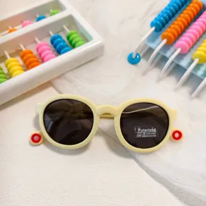 Kids polarized sunglasses detail shot, cute yellow round frame with anti-uv protection.