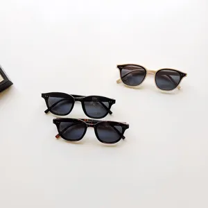 Kids fashion rivet sunglasses detail view, UV400 protection clear lenses summer outdoor wear.