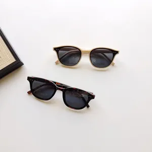 Close-up detail view of stylish kids sunglasses in two fashionable frame colors.