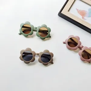 Close-up detail of cute floral children sunglasses in multi-color styles, flat lay.