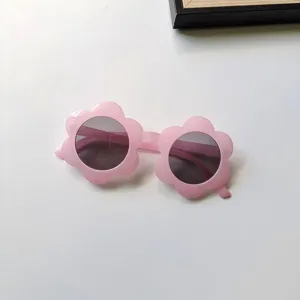 Detailed view of cute pink flower sunglasses for kids, featuring fun floral design.