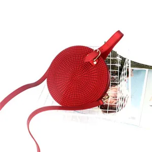 Red round crossbody bag for women, stylish circular shoulder bag with adjustable strap.