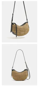 Stylish summer straw woven crossbody bag with black leather trim, casual half-moon shoulder handbag.