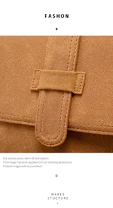 Detailed close-up of vintage brown faux suede cross-body bag strap and neat stitching.