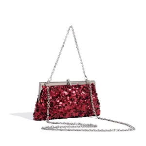 Red sequin evening bag detail showcasing glittering sequins and an elegant silver chain strap.
