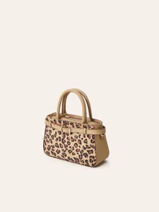 Detailed view of women leopard print handbag with cork texture and tan leather handles.