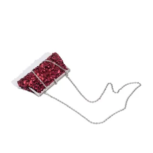 Detail view of red sequin evening clutch bag with metal chain strap for party dress