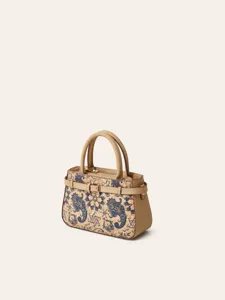 Cork texture handbag detail with blue paisley pattern and beige leather trim elements.