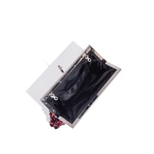 Closeup of sequin evening bag interior, elegant metal frame and black lining design.