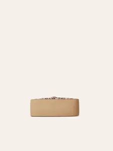 Detailed bottom view of a stylish women handbag featuring solid beige and leopard print design.