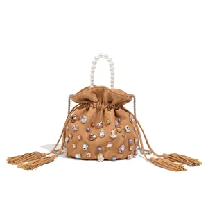 Detailed view of the stylish khaki crystal embellished bucket bag featuring pearl handle.