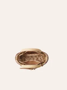 Top view of a chic beige women handbag showcasing internal lining and structured compartments.