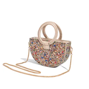 Detailed view of the sparkling rhinestone and pearl half-moon evening bag with chic braided handle.
