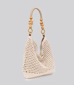 Crochet woven shoulder bag with wooden beaded handle, hollow-out beige beach tote detail.
