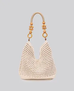 Beige crochet shoulder bag detail, handcrafted woven cotton material with wooden bead handle.