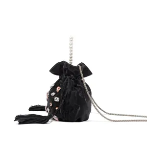 Detail shot of black velvet bucket bag with rhinestones, pearls and metallic chain.