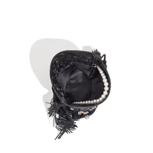Detail view of black satin bucket bag featuring elegant faux pearl handle and crystal rhinestones.
