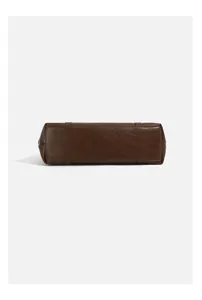 Brown leather handbag bottom detail, retro underarm bag design, stylish autumn winter accessory.
