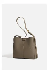 Close-up detail showing premium leather texture and hardware buckle of the shoulder bag.