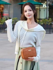 Chic quilted crossbody bag for women, stylish brown shoulder bag with metal accent and strap.