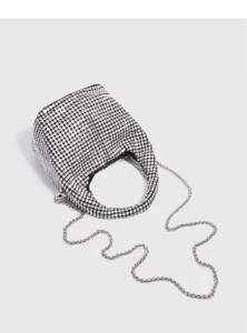 Rhinestone crystal bucket bag detail shot showing sparkling surface and sleek metal chain handle.