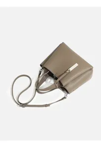 Women's casual shoulder crossbody bag detail view, textured leather material with metal accent.