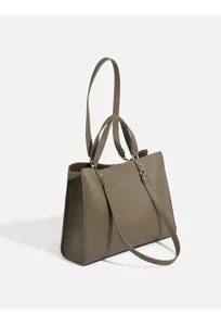 Detailed view of the stylish litchi texture leather tote bag in taupe with shoulder strap.