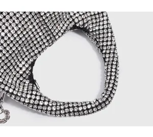 Women fashion silver rhinestone mesh handbag detail shot, elegant sparkling crystal evening purse.