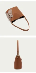 Brown PU leather bucket bag detail view with stylish paisley scarf and metal hardware.
