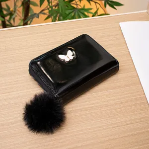Women short glossy wallet with cute butterfly metal decor and plush ball pendant casual design.