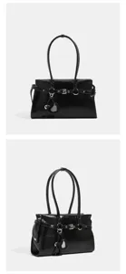 Black patent leather shoulder bag with stylish belt buckle and heart charm for women.