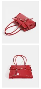 Red patent leather motorcycle shoulder bag with buckle straps and heart mirror detail.