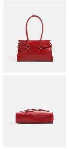 Red patent leather shoulder underarm bag detail view showcasing metal ring and belt decor.