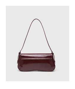 Glossy patent leather burgundy baguette shoulder bag with chic flap and elegant curved design.