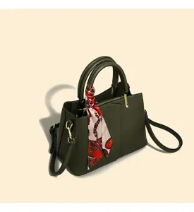 Dark green leather handbag detail, stylish patterned silk scarf accent and shoulder strap.