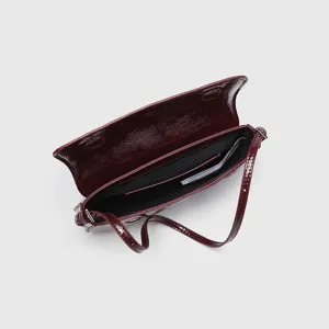 Burgundy patent leather baguette shoulder bag for women, stylish vintage underarm purse.