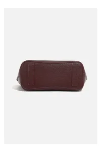 Detail view of women's fashion leather handbag bottom, casual daily shoulder bag design.