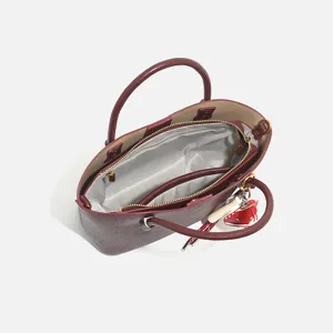 Burgundy leather handbag for women, stylish tote shoulder bag with top handles and spacious interior.