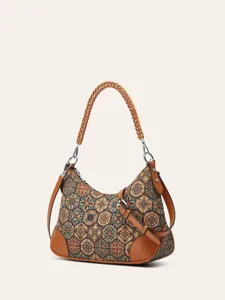 Close-up of ethnic print cork shoulder bag with braided handle and brown leather trim.
