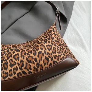 Leopard print shoulder bag detail view, soft plush material with brown PU leather trim accent.