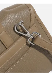 Detail view of women trendy crossbody bag with premium leather and metal hardware.